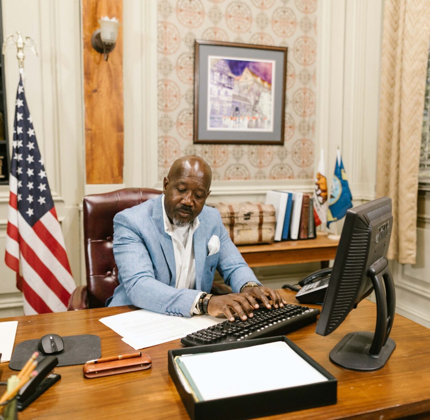 Lawyer in blue suit working on a computer in his office