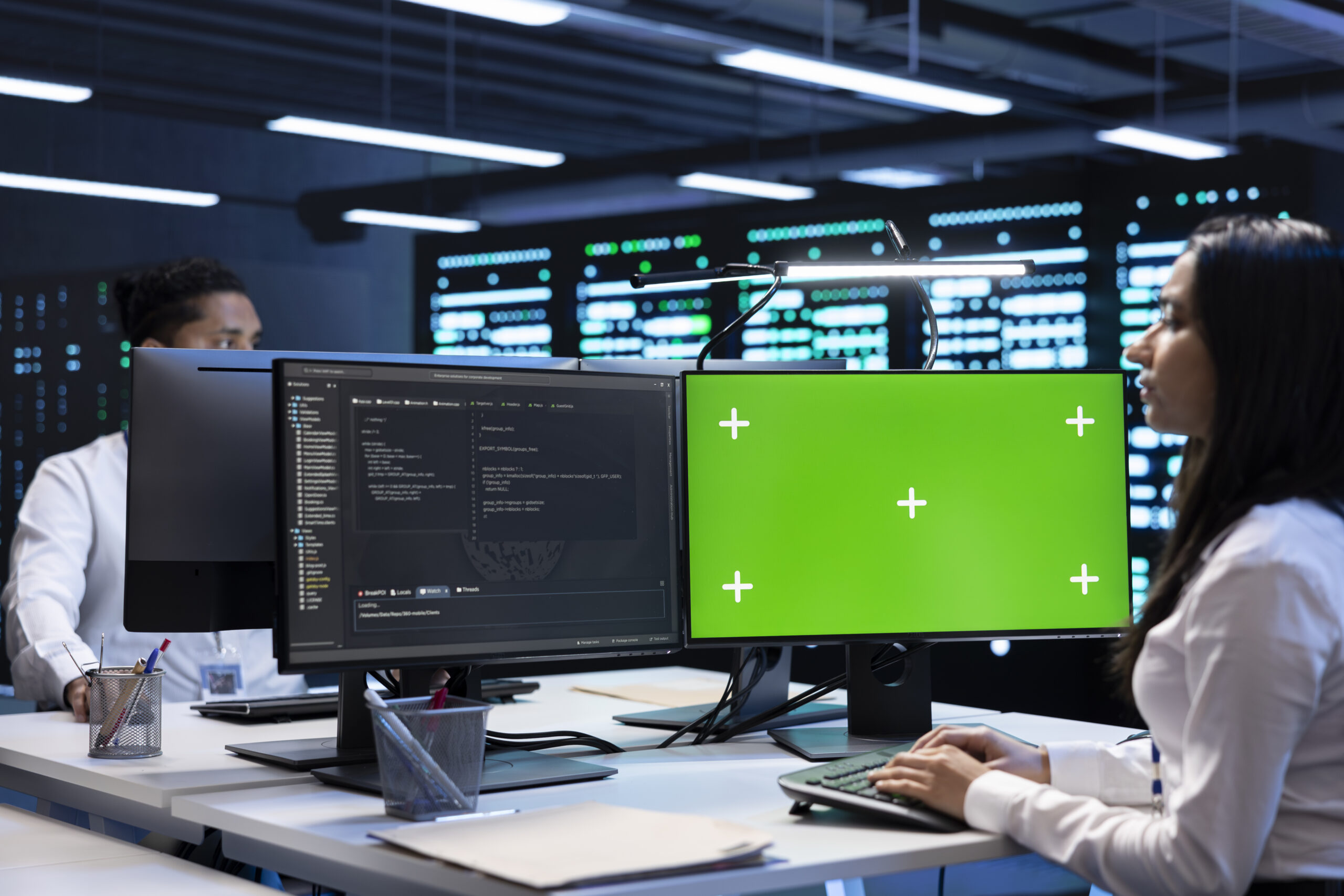 Specialists using green screen PC to check server clusters